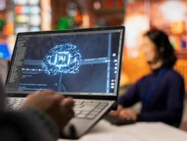 call-center-worker-using-ai-tech-laptop-reply-customers-closeup-scaled